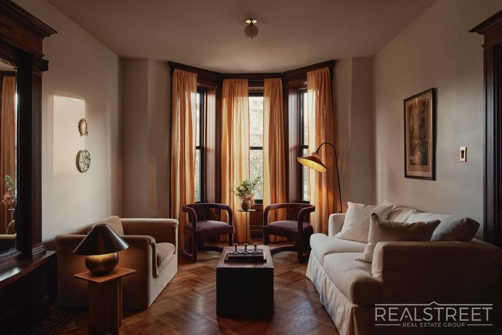 Warm living room with original woodwork at 939 St. Johns Place #2