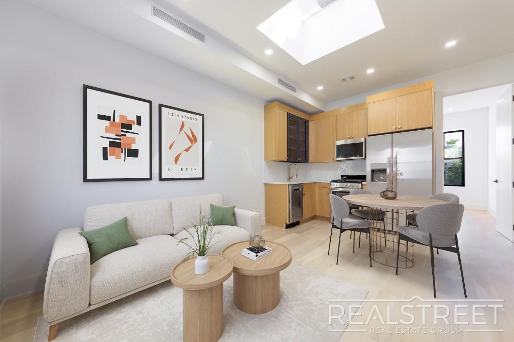 Skylit living room and open kitchen at 79 Willoughby Avenue #4